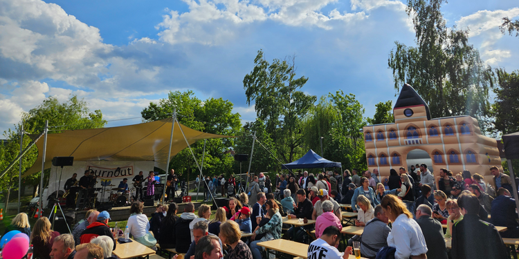 Blick auf Bürgerpark mit vielen Menschen, Bühne und Hüpfburg