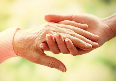 36591101 - old and young holding hands on light background, closeup