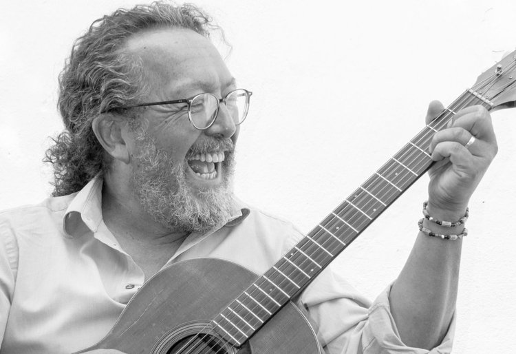 schwarz-weiß Foto von Jimmy im Hemd und Gitarre spielend